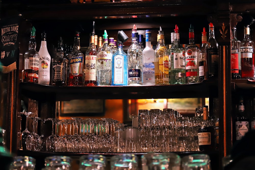 a shelf filled with lots of bottles and glasses