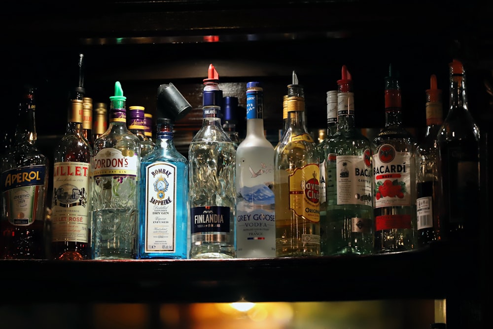 a shelf filled with lots of bottles of alcohol