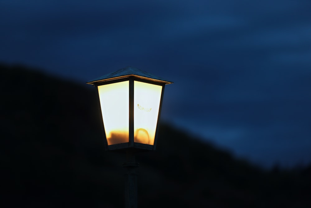 a street light with a dark sky in the background