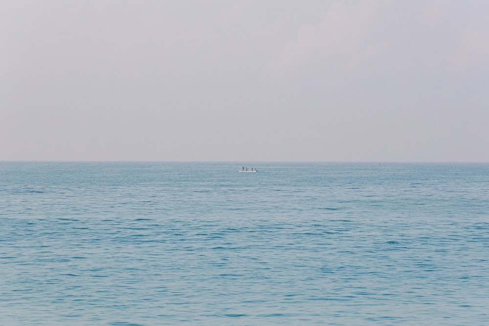 a lone boat in the middle of the ocean