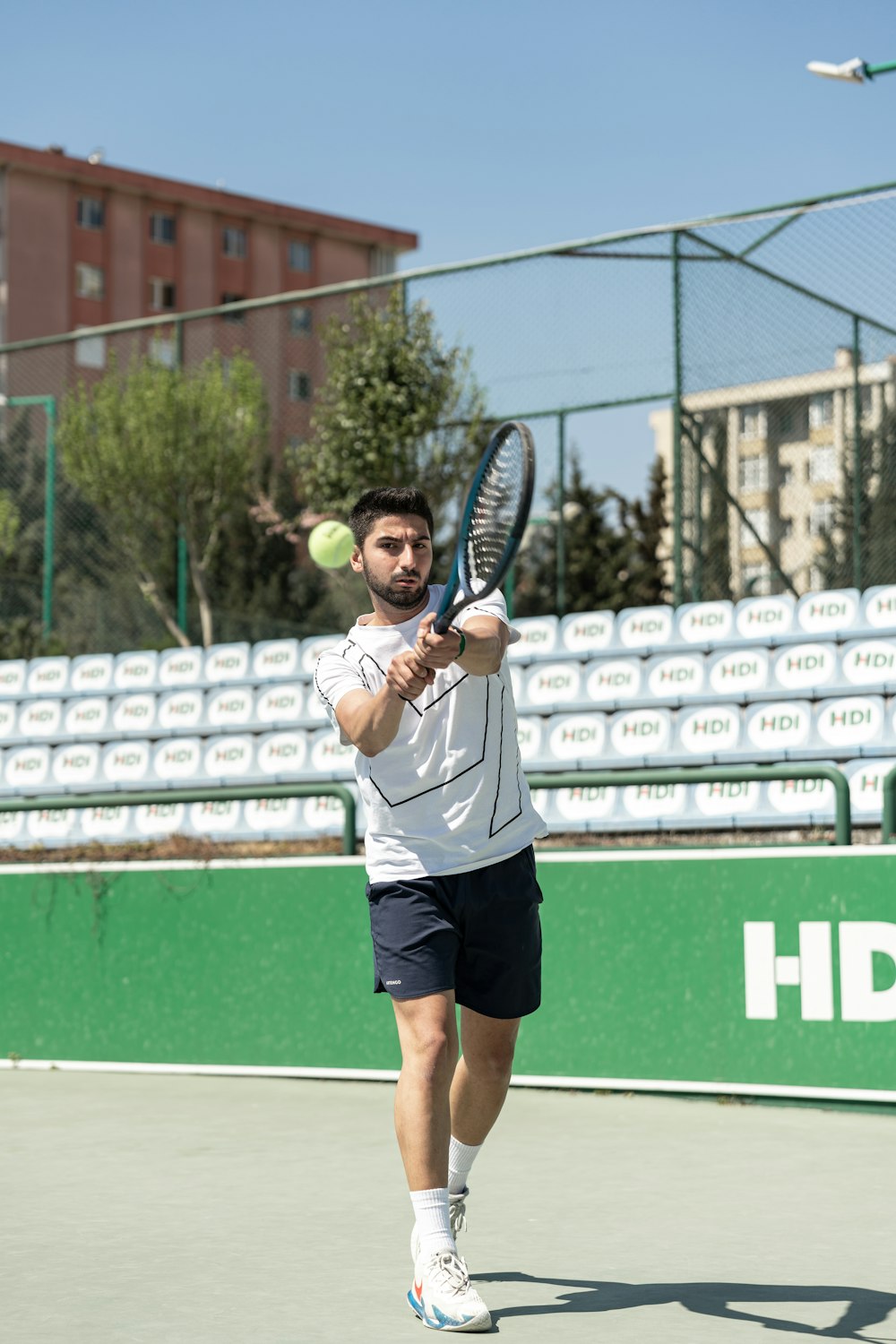 a man holding a tennis racquet on a tennis court