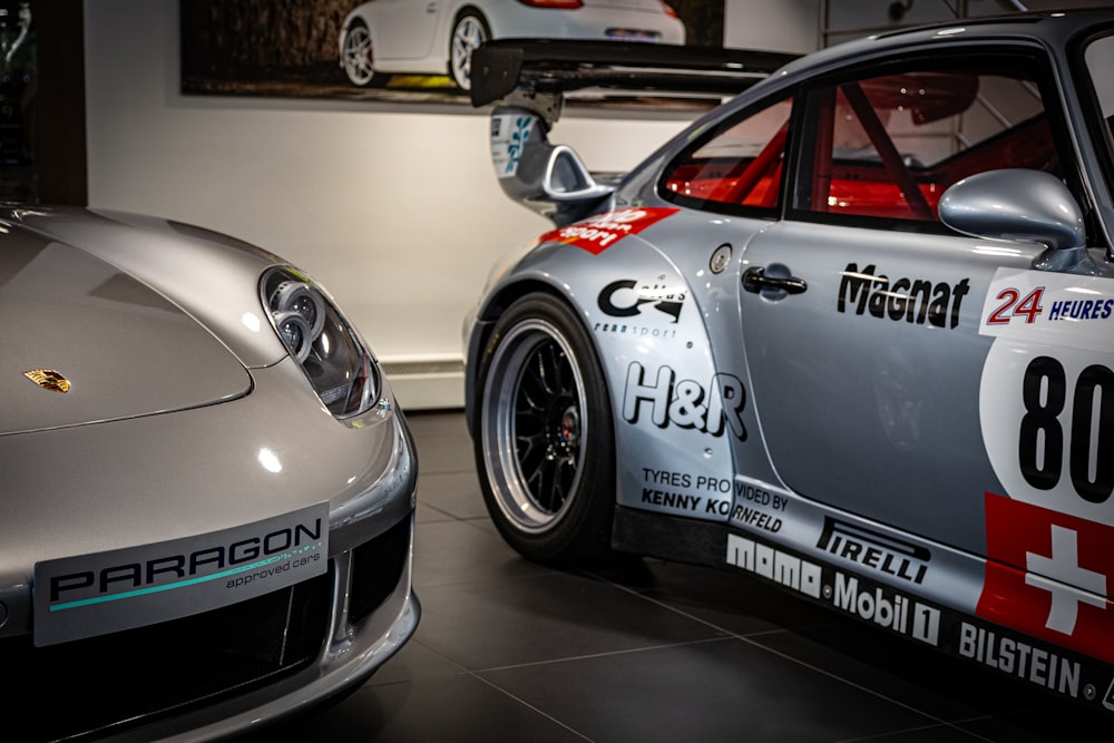 two porsche sports cars parked next to each other