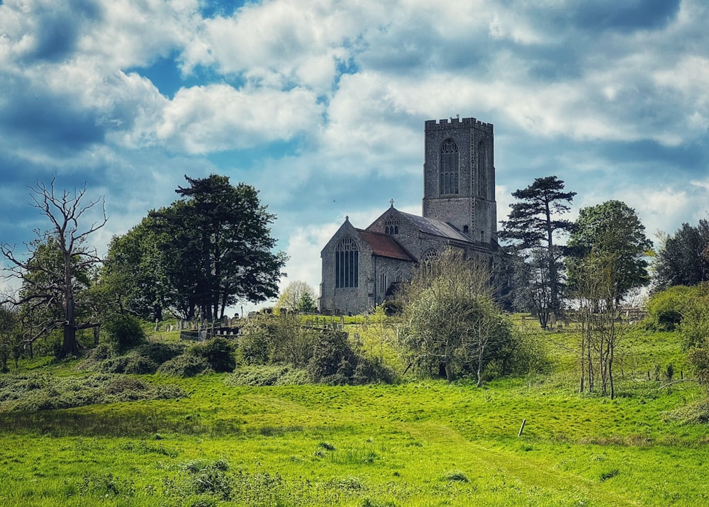 a church on a hill surrounded by trees