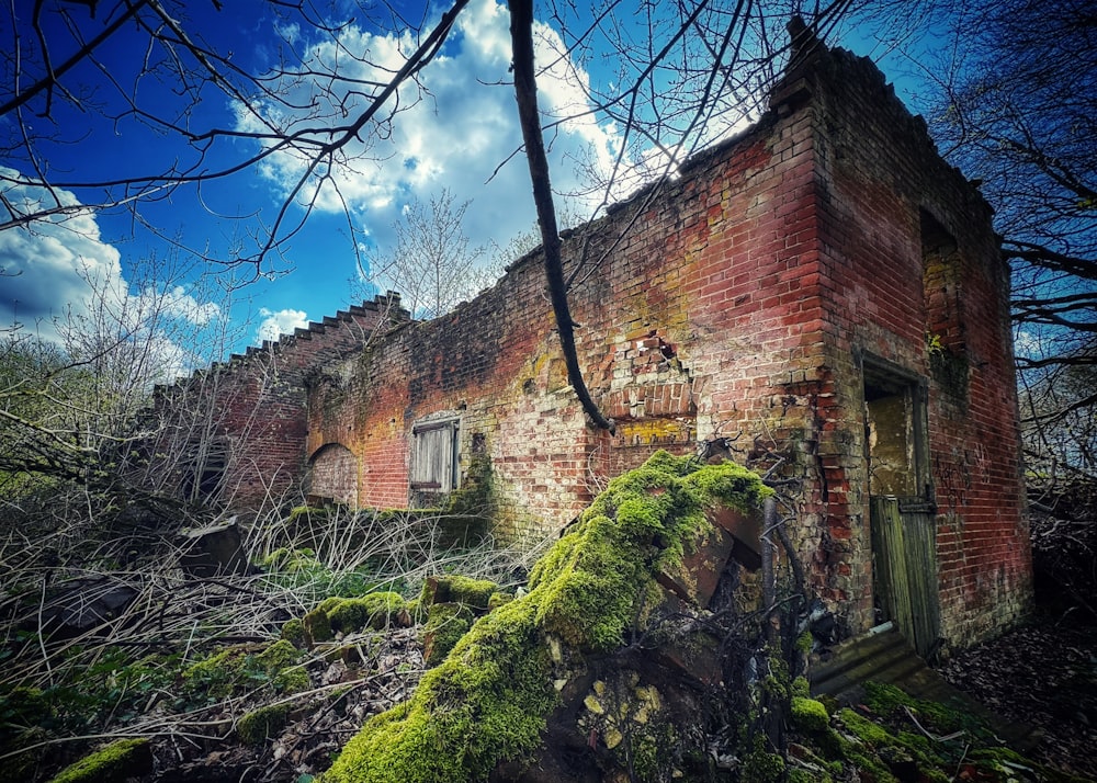 an old brick building with moss growing on it