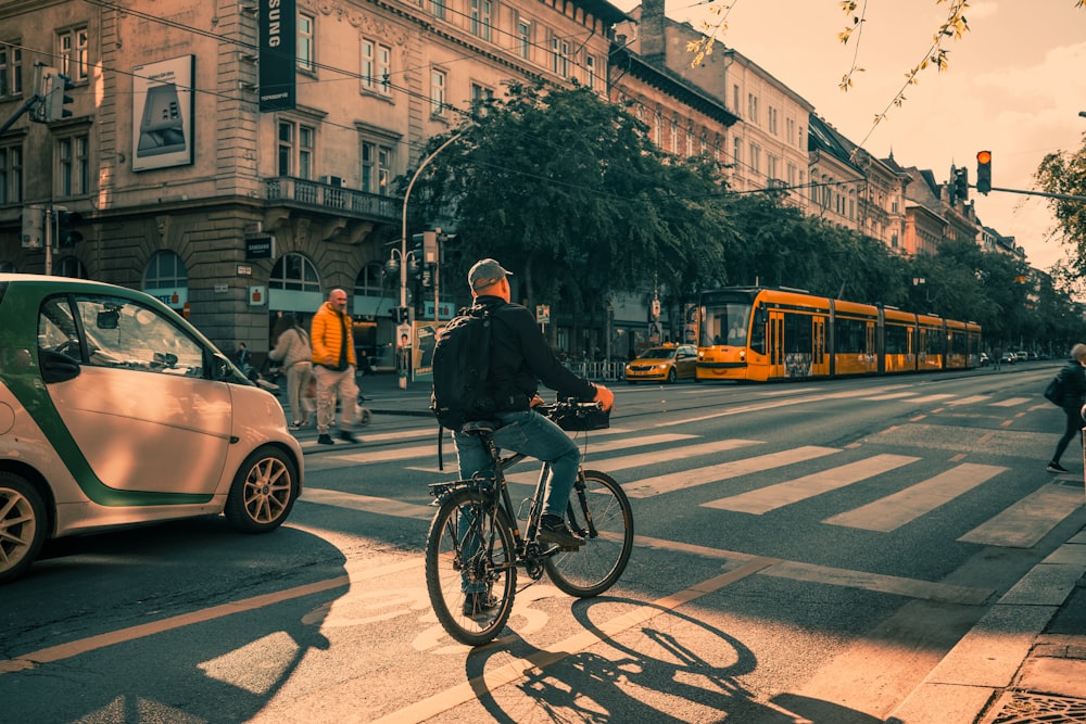 a man riding a bike across a street