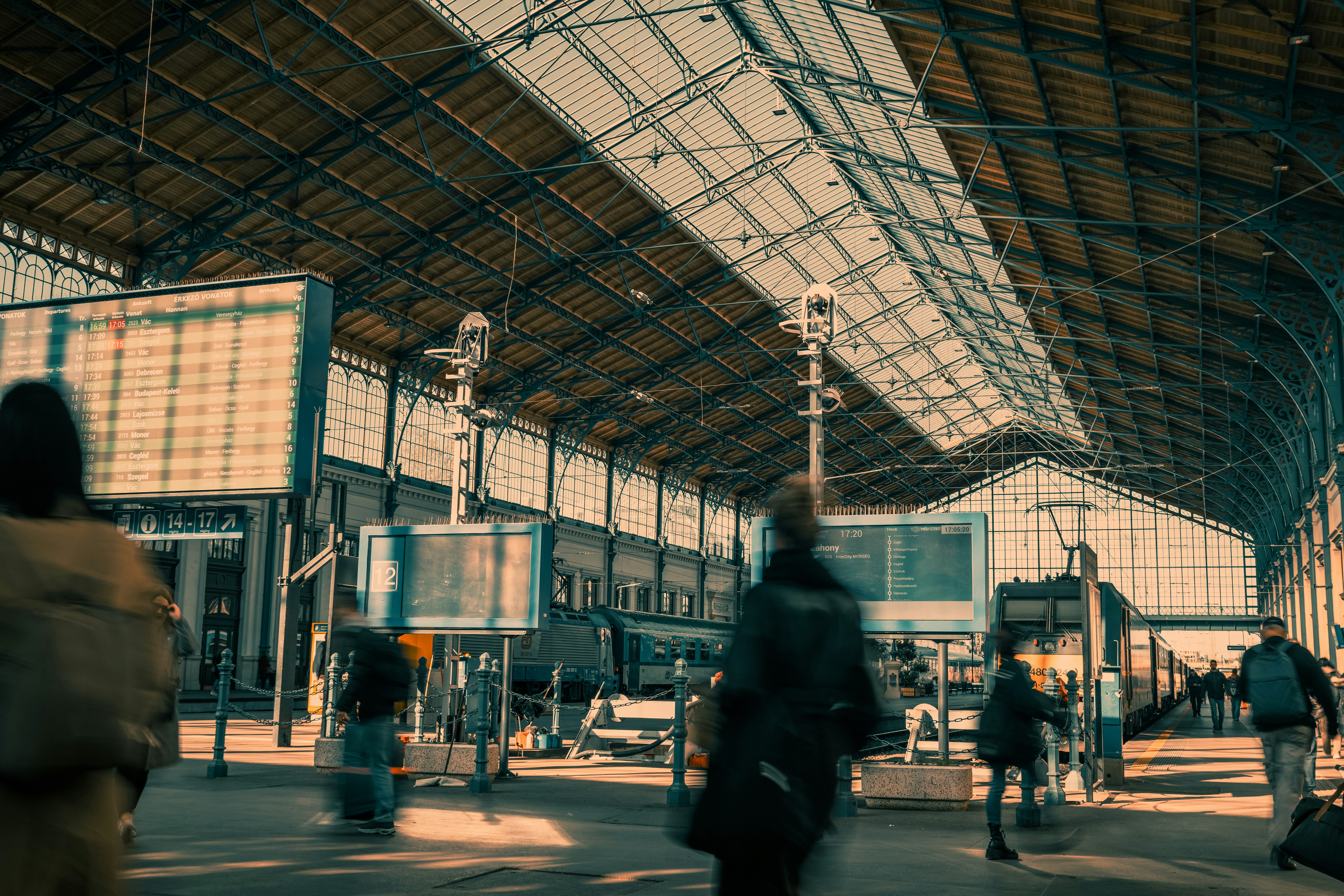 a group of people walking through a train station
