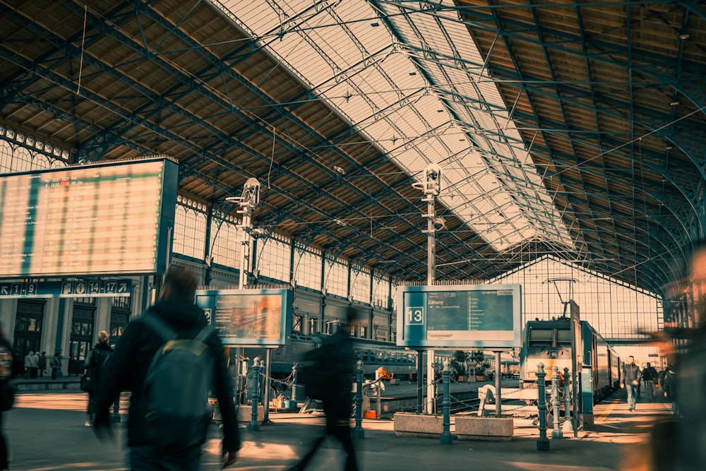 a group of people walking through a train station