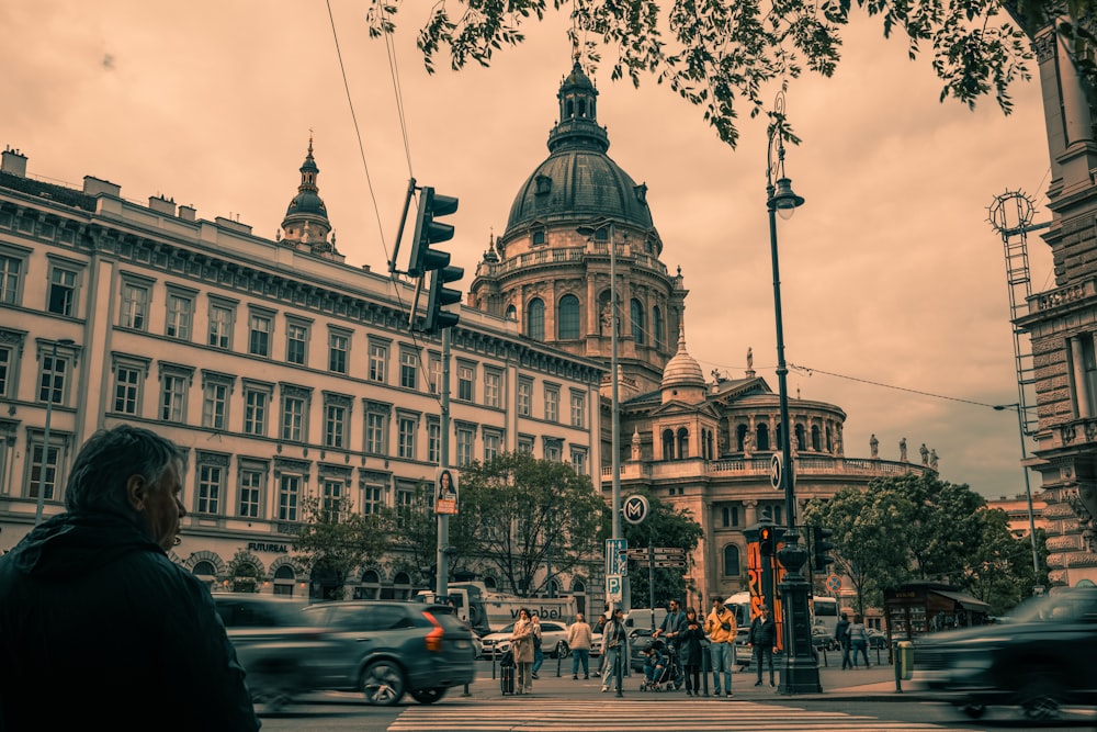 a busy city street with a large building in the background