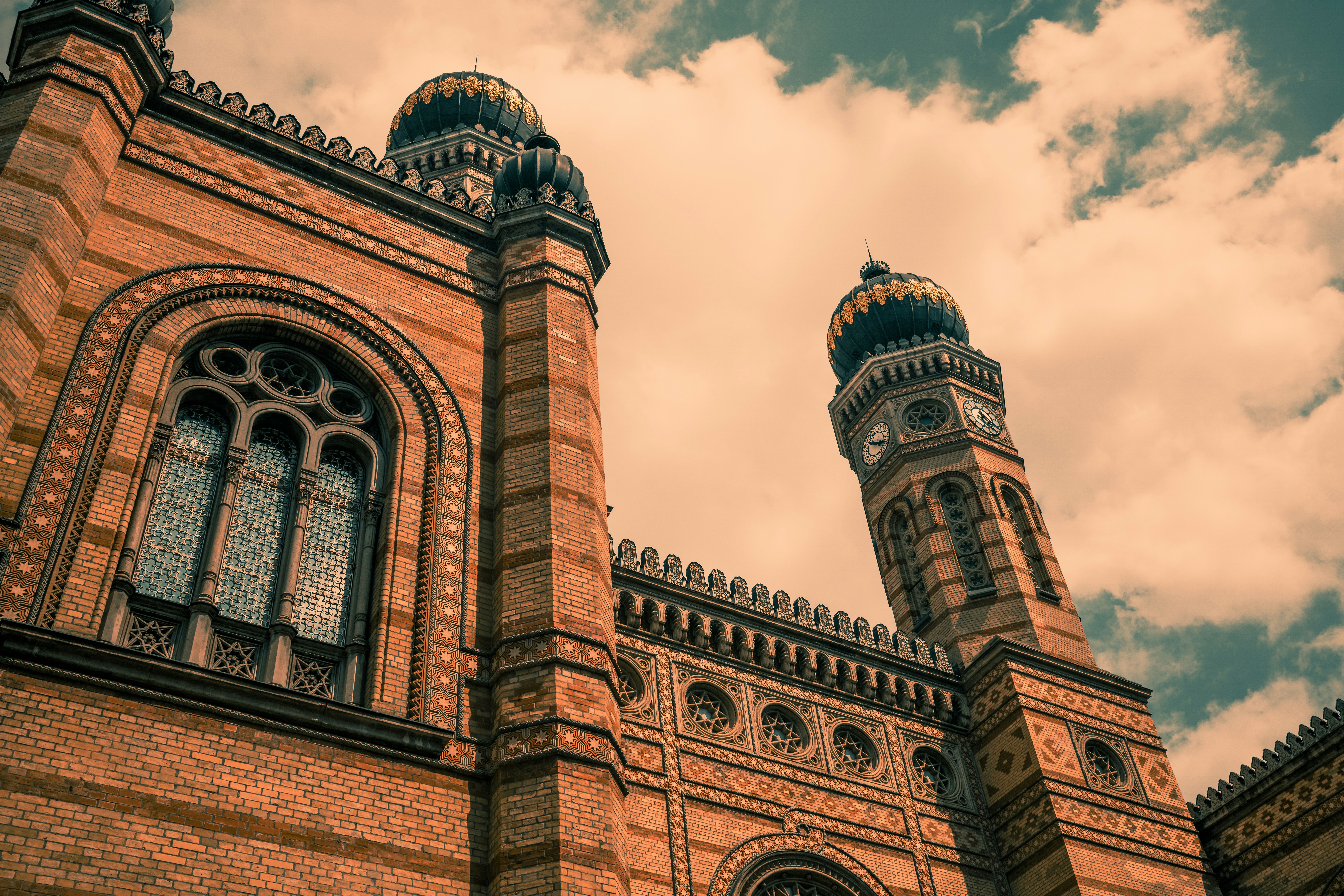 a large brick building with two towers and a clock