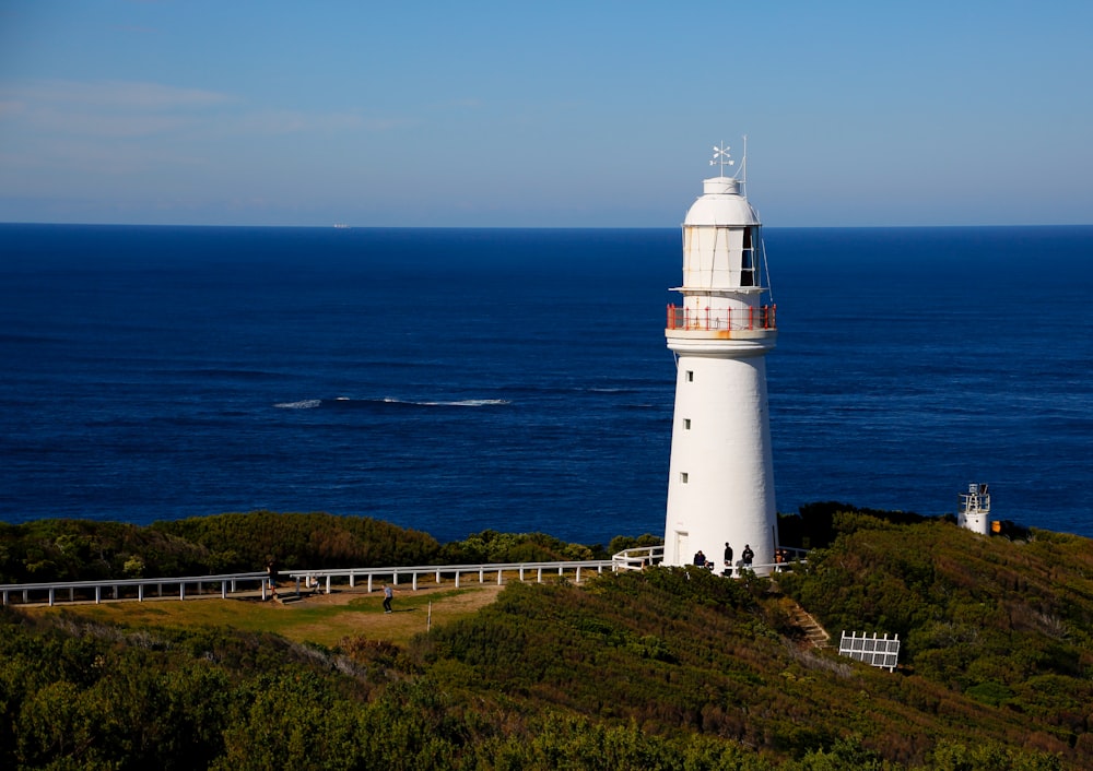 a lighthouse on a hill overlooking the ocean