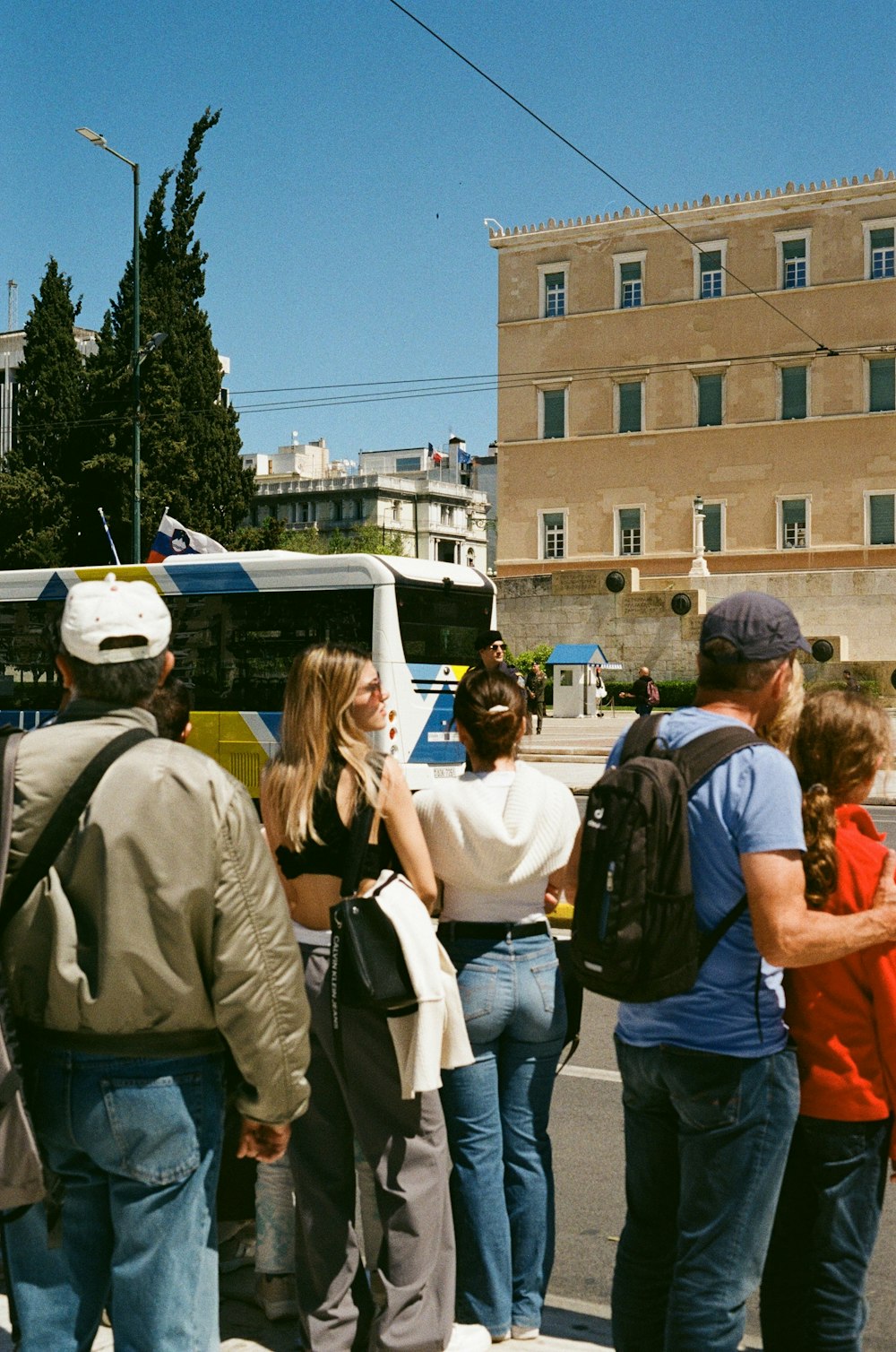 a group of people waiting at a bus stop