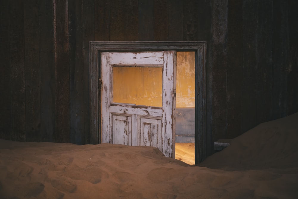 a door in the middle of a sand dune