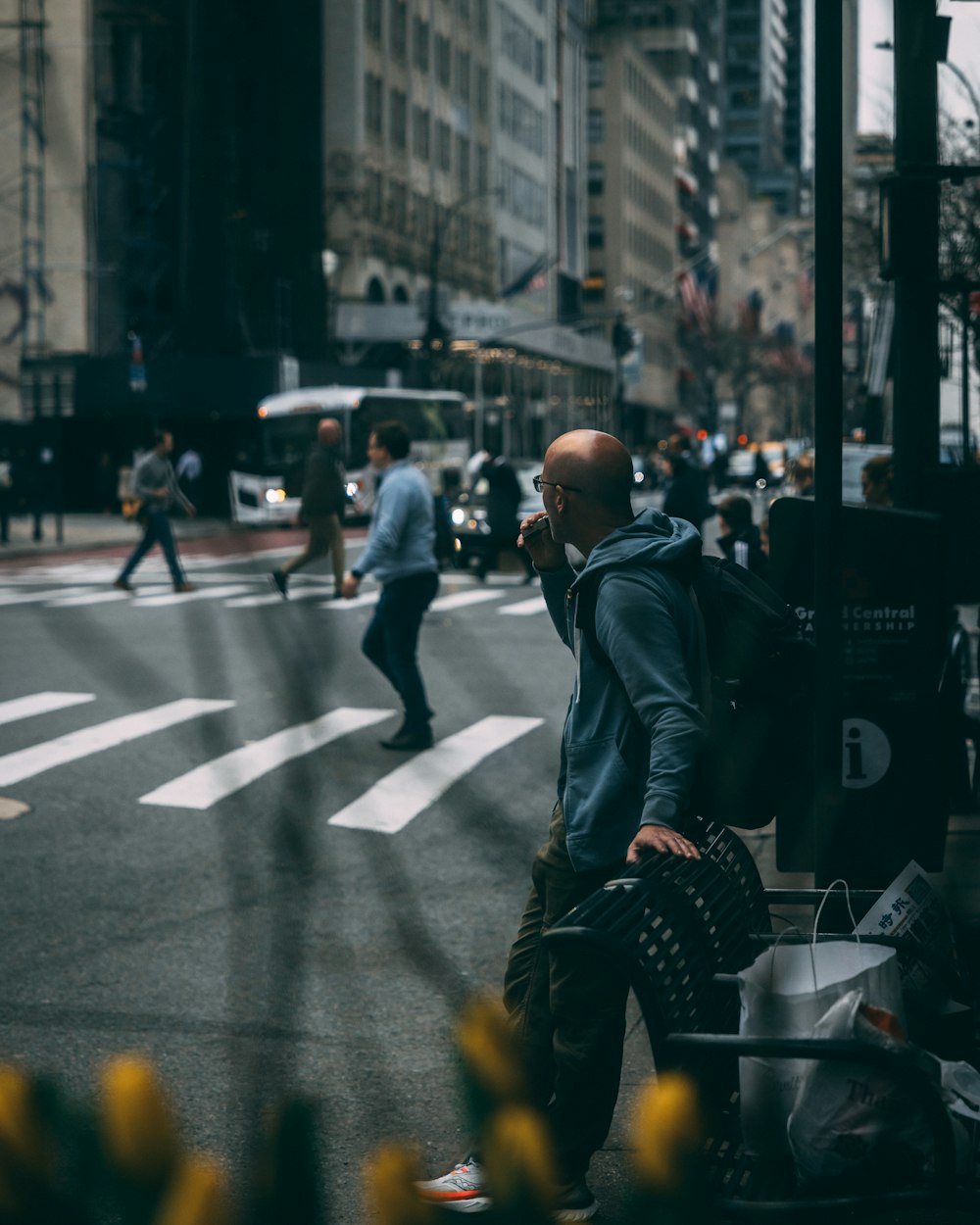 a man walking down a street talking on a cell phone