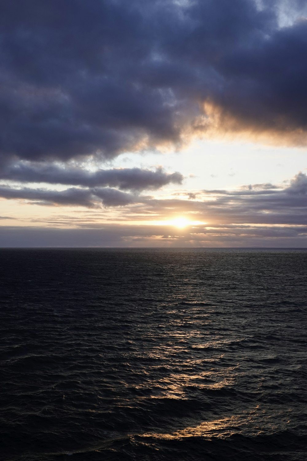 a large body of water under a cloudy sky