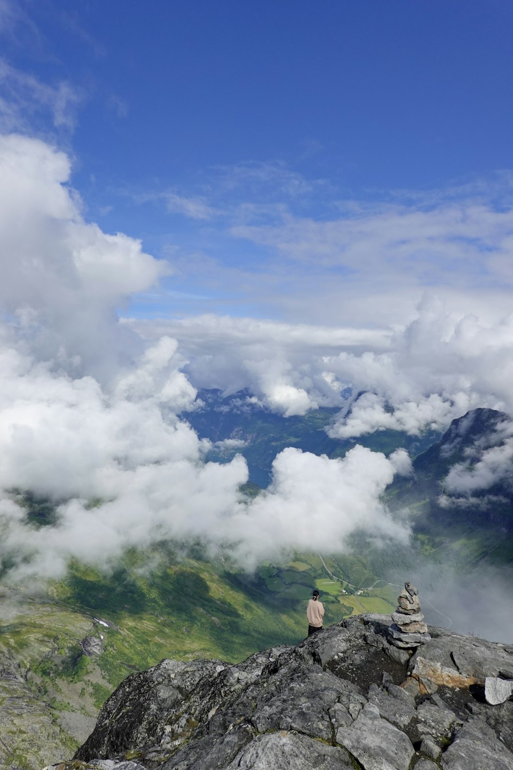 a person sitting on top of a mountain