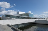 a large white building sitting next to a body of water