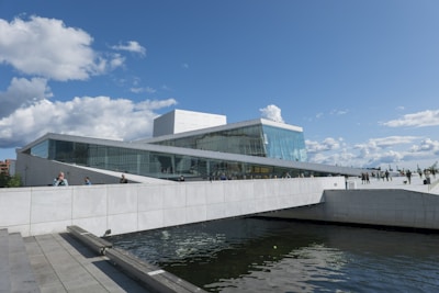a large white building sitting next to a body of water