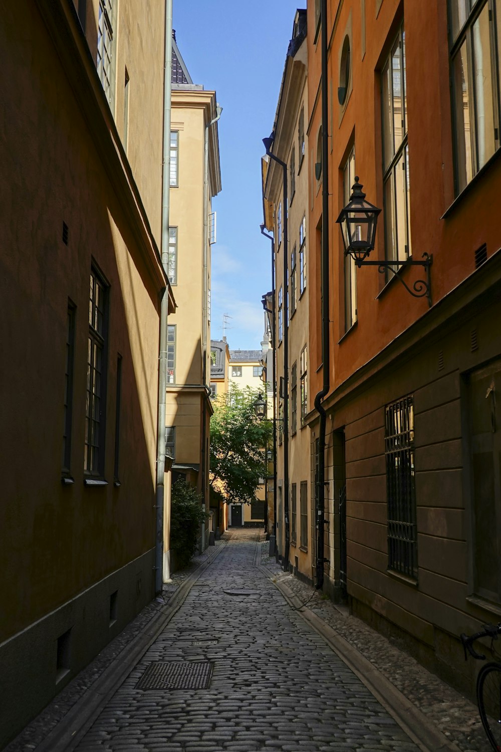 a narrow cobblestone street in a european city