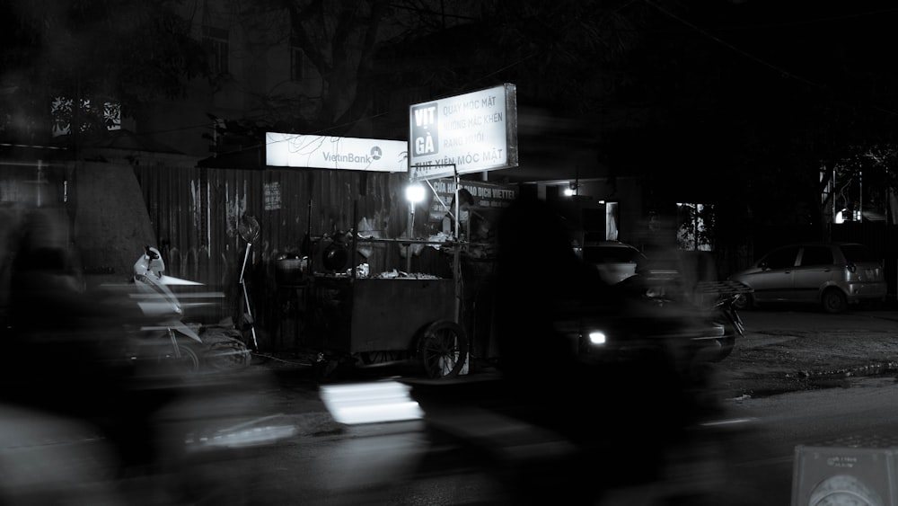 a black and white photo of a food cart