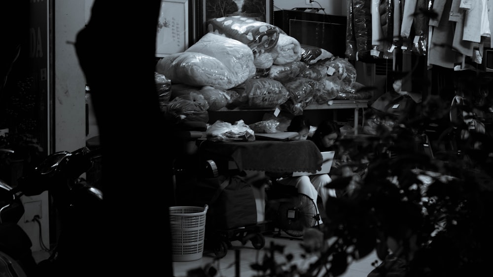 a black and white photo of a person sitting at a table