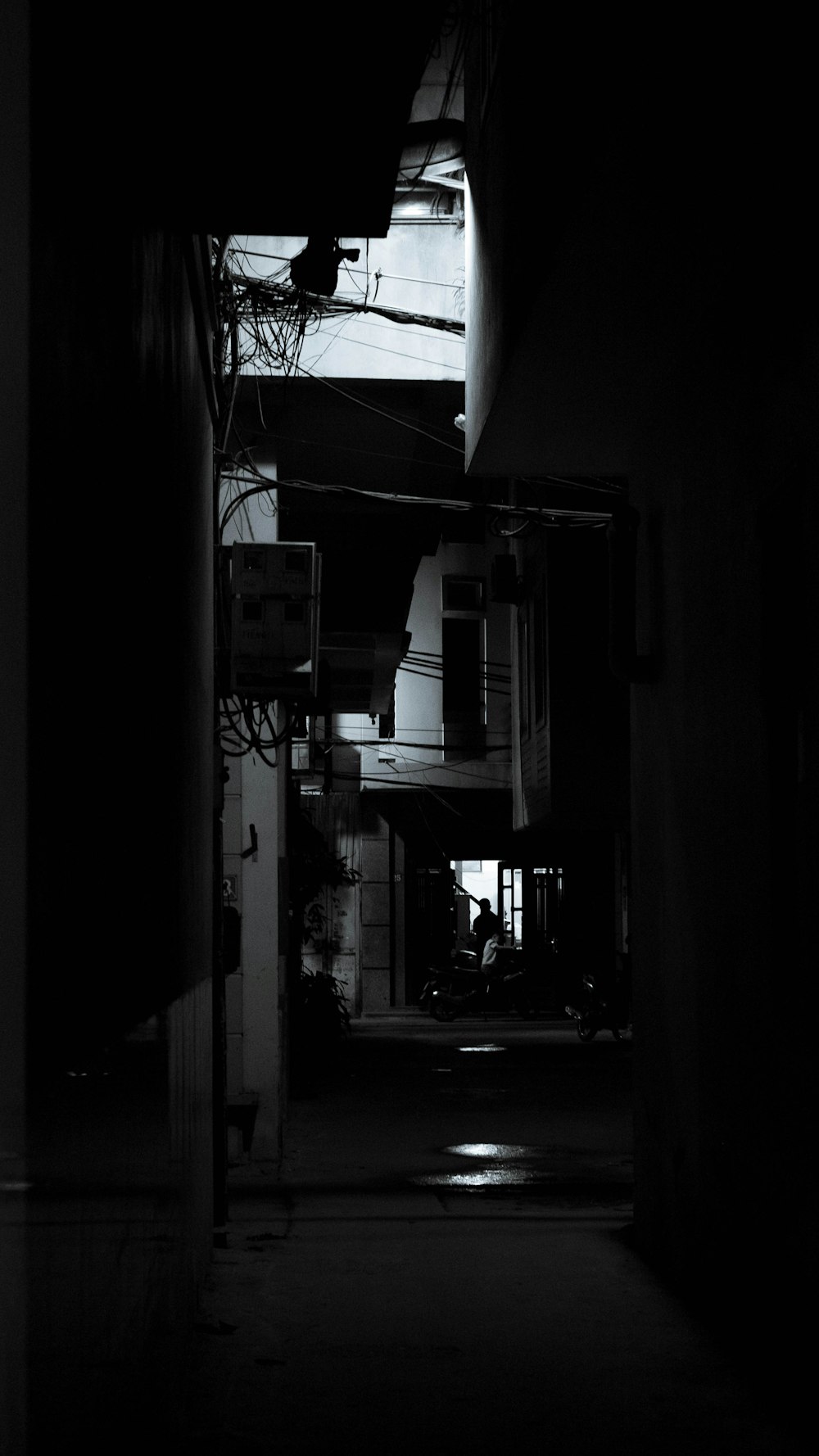 a black and white photo of a dark hallway