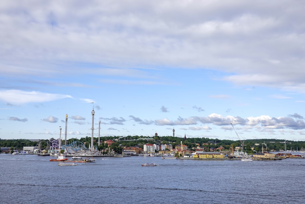 a harbor filled with lots of boats under a cloudy blue sky