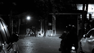 a man riding a motorcycle down a street at night