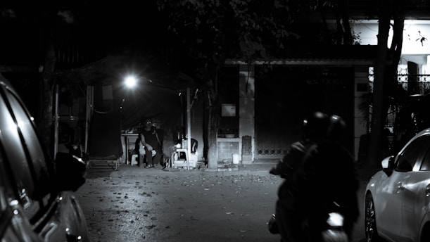 a man riding a motorcycle down a street at night