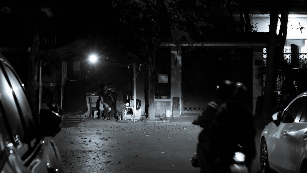 a man riding a motorcycle down a street at night