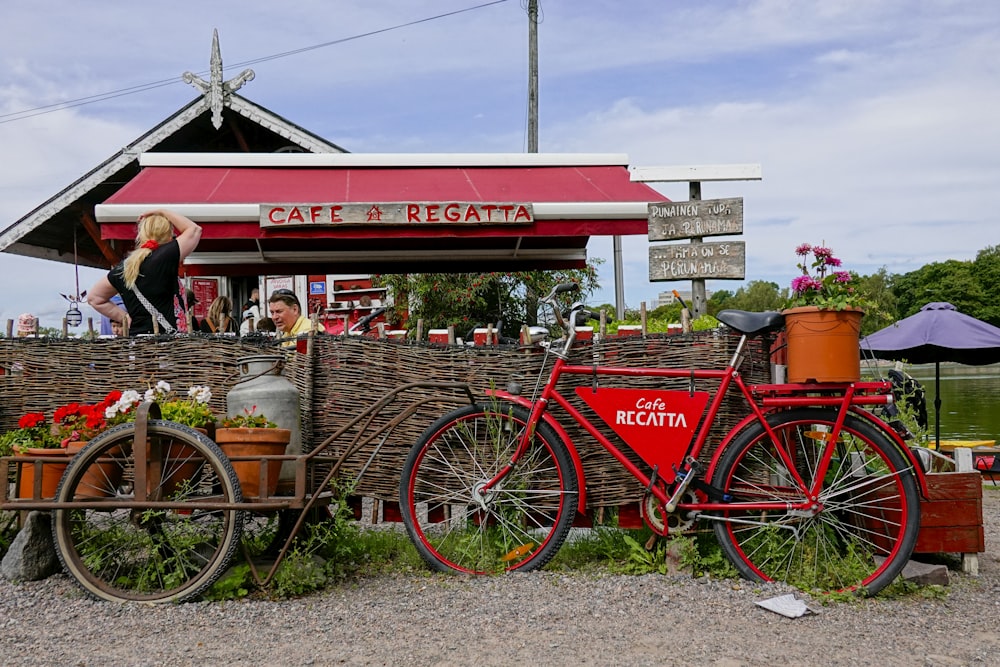 a red bicycle parked next to a building