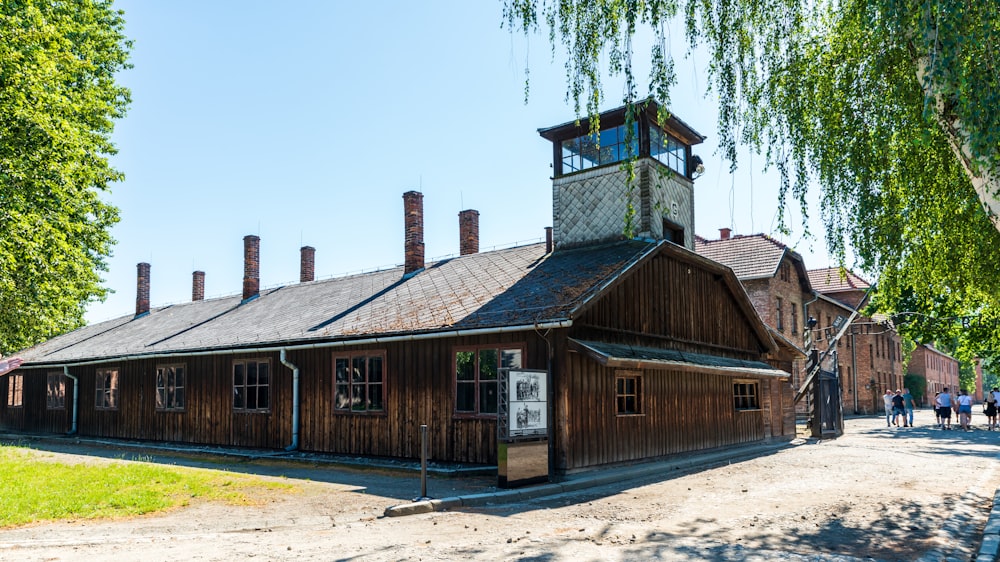 a wooden building with a clock tower on top of it