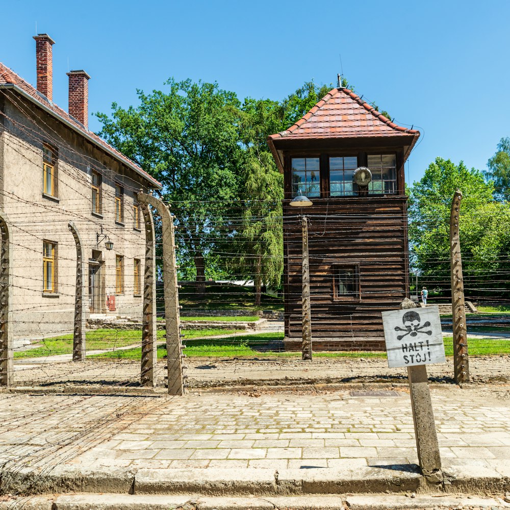 a wooden building with a sign in front of it