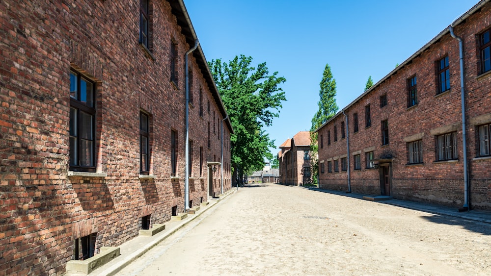 a narrow street with brick buildings on both sides