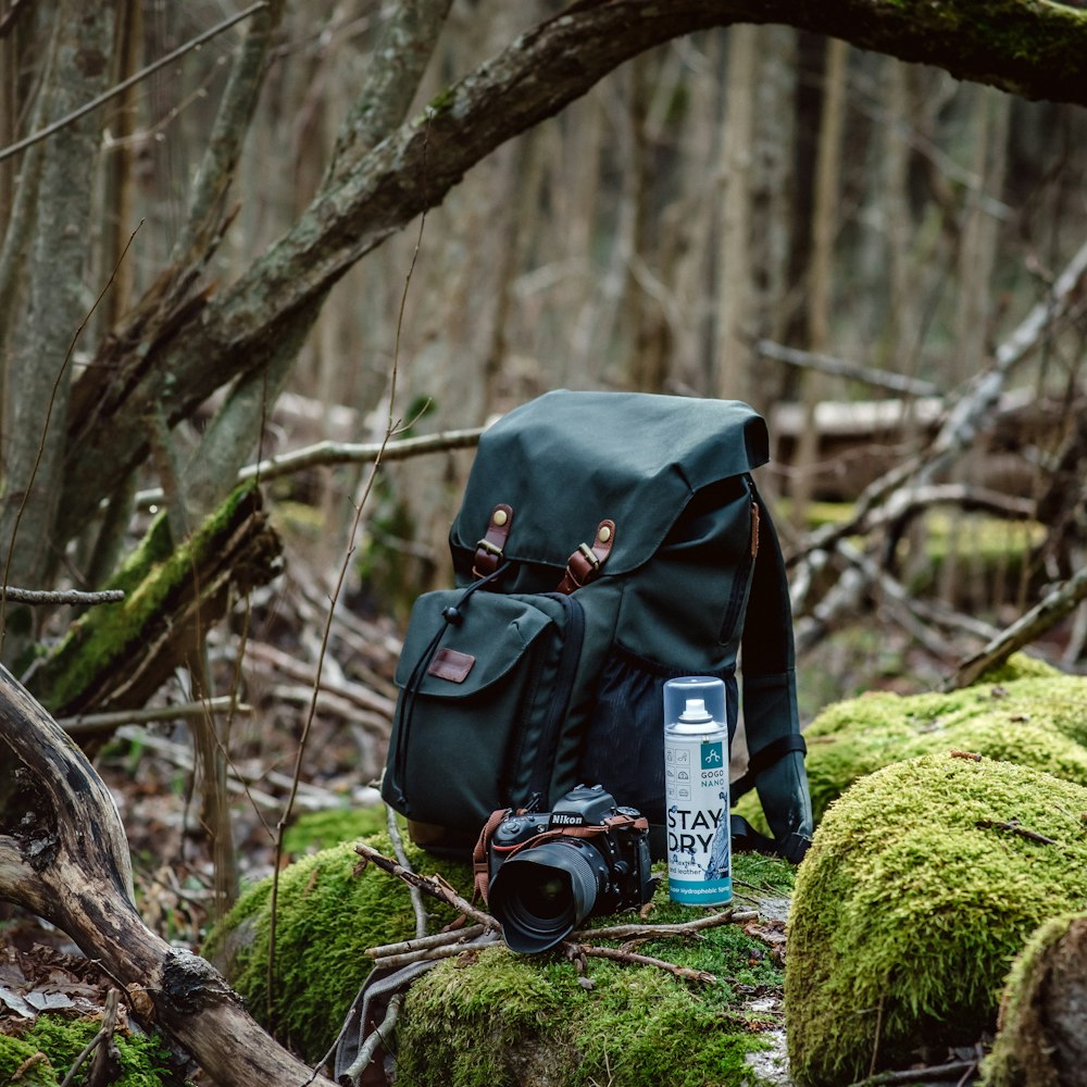 a backpack sitting on top of a moss covered forest