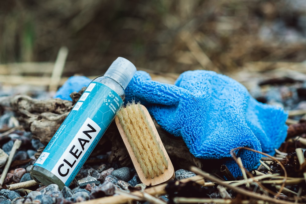 a close up of a blue glove and a tube of clean