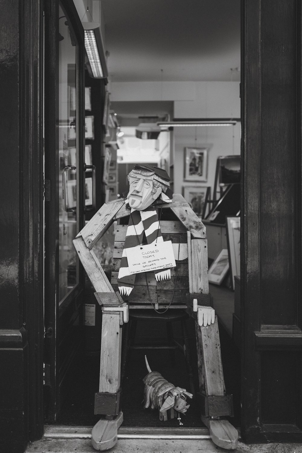 a man sitting in a chair with a dog in front of him