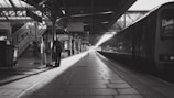 a train pulling into a train station next to a platform