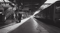 a train pulling into a train station next to a platform