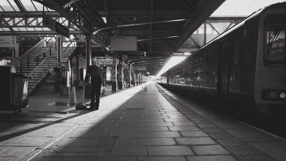 a train pulling into a train station next to a platform