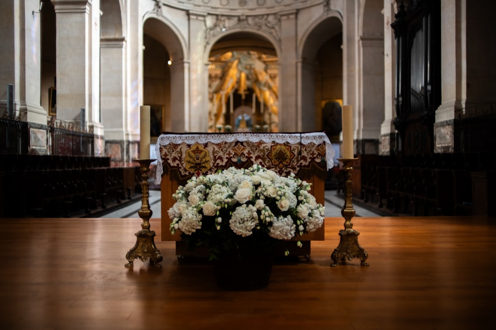 a church with a floral arrangement on the alter