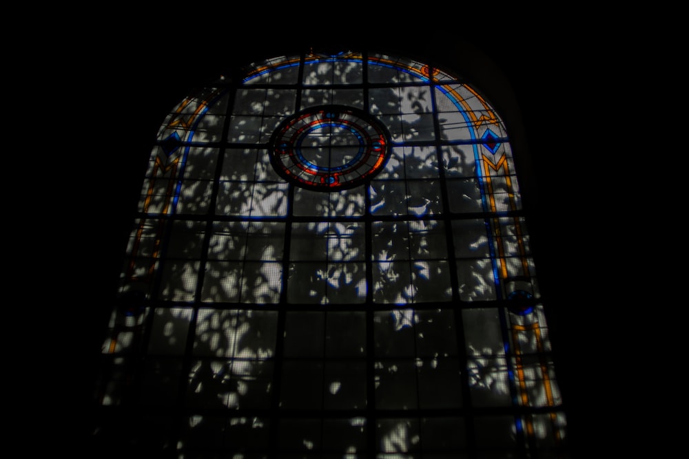a large stained glass window with a clock on it