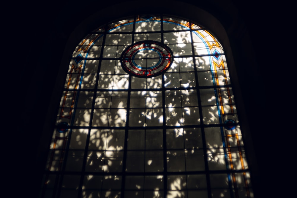 a stained glass window with a clock on it