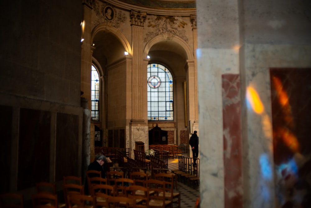 a couple of people that are standing in a church