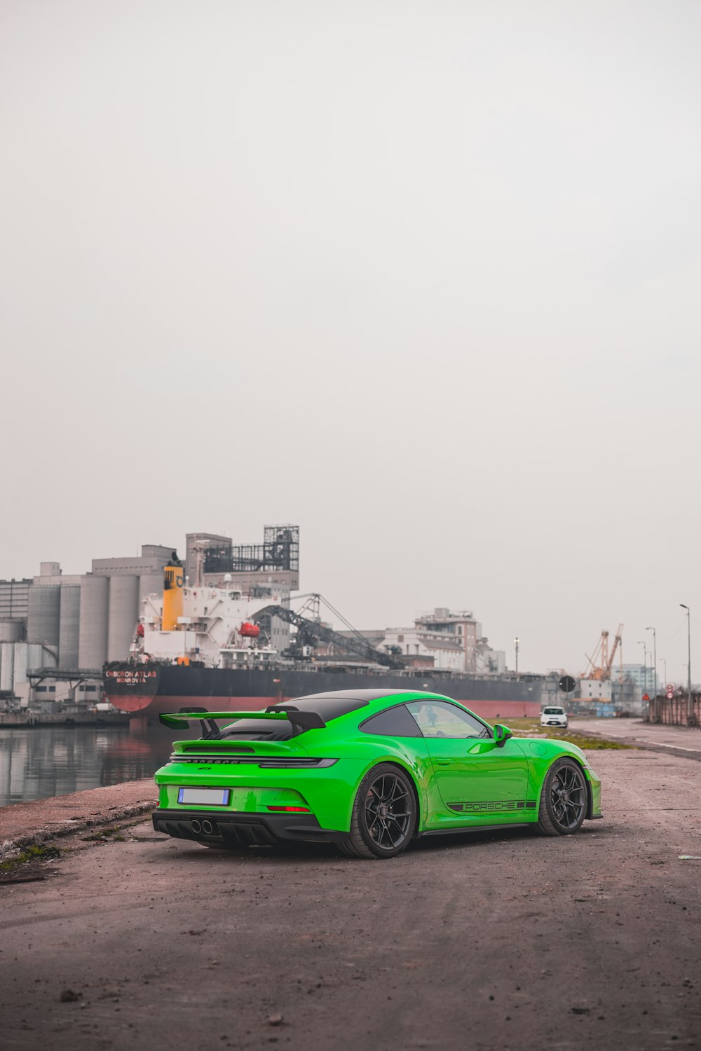 a green sports car parked on the side of the road