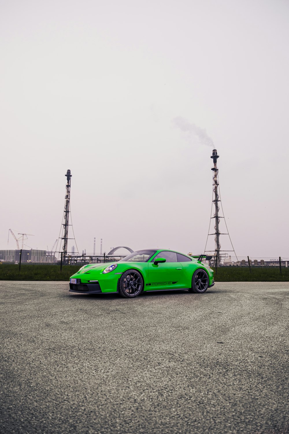 a green sports car parked in a parking lot