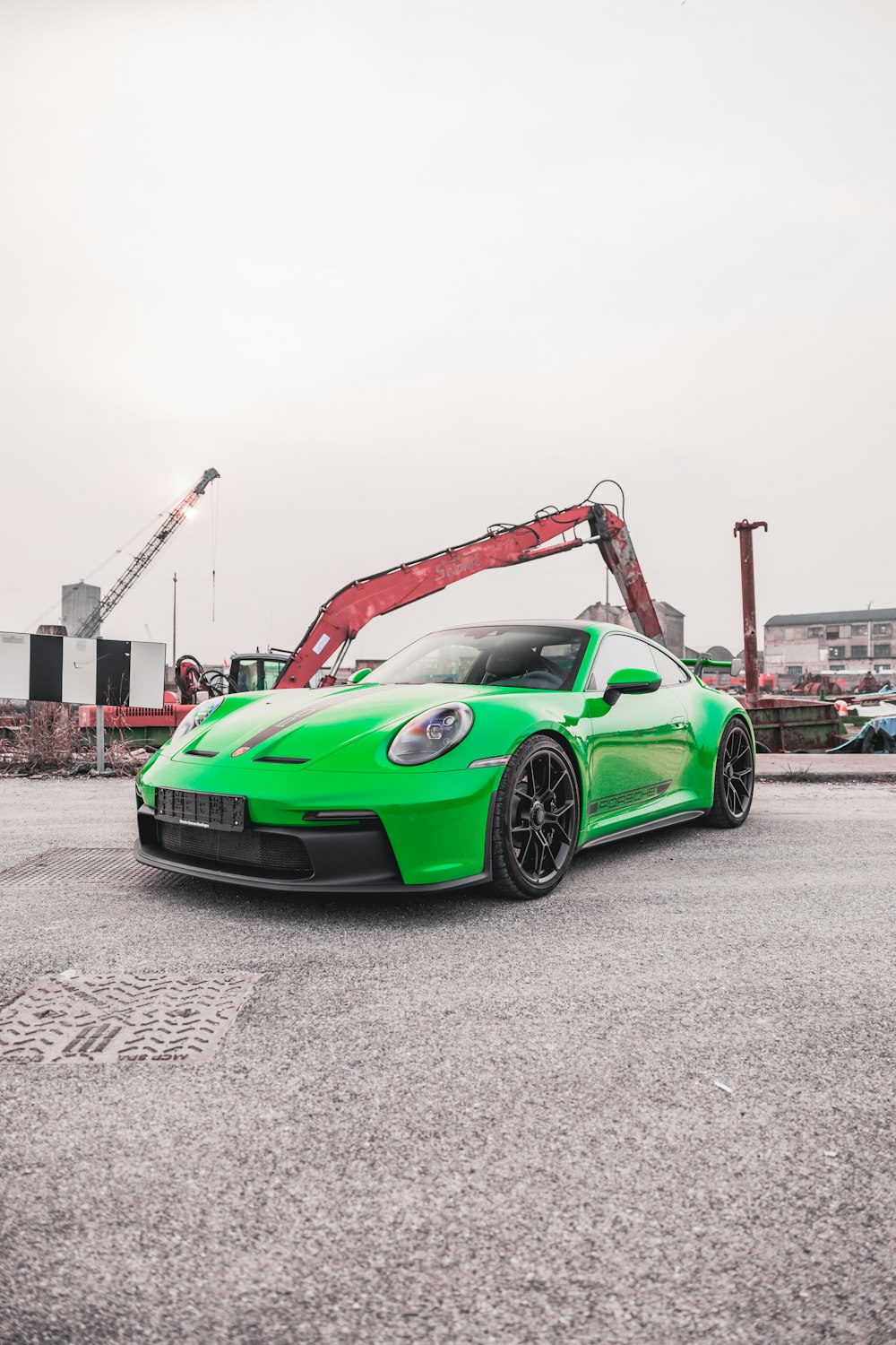 a green sports car parked in a parking lot