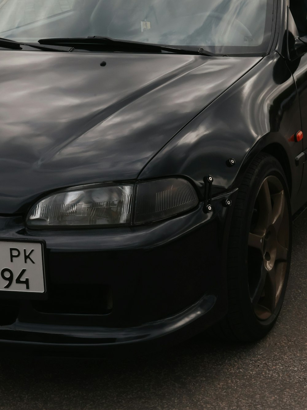 a black car parked on the side of the road