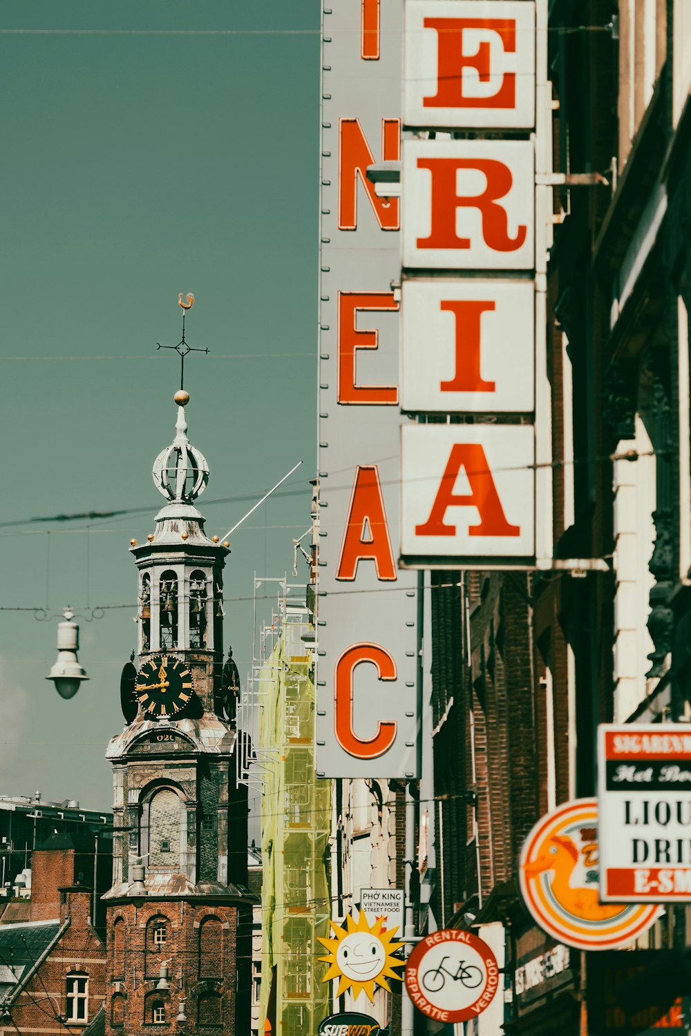 a city street with a clock tower in the background