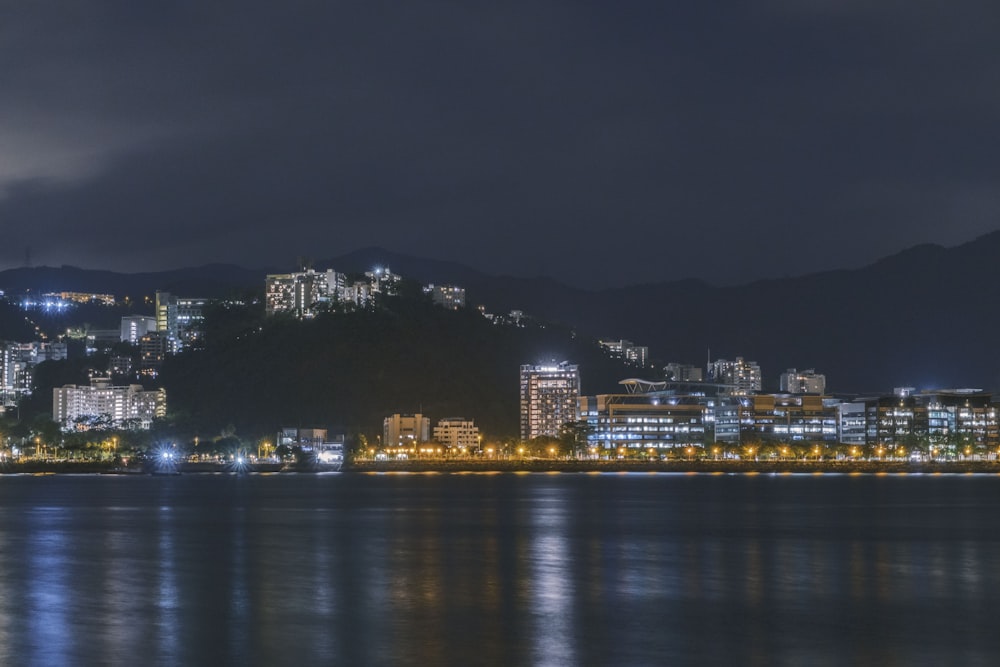 a night view of a city and a body of water