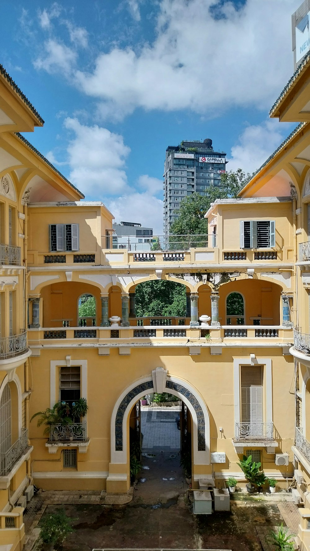 a large yellow building with a clock tower in the background